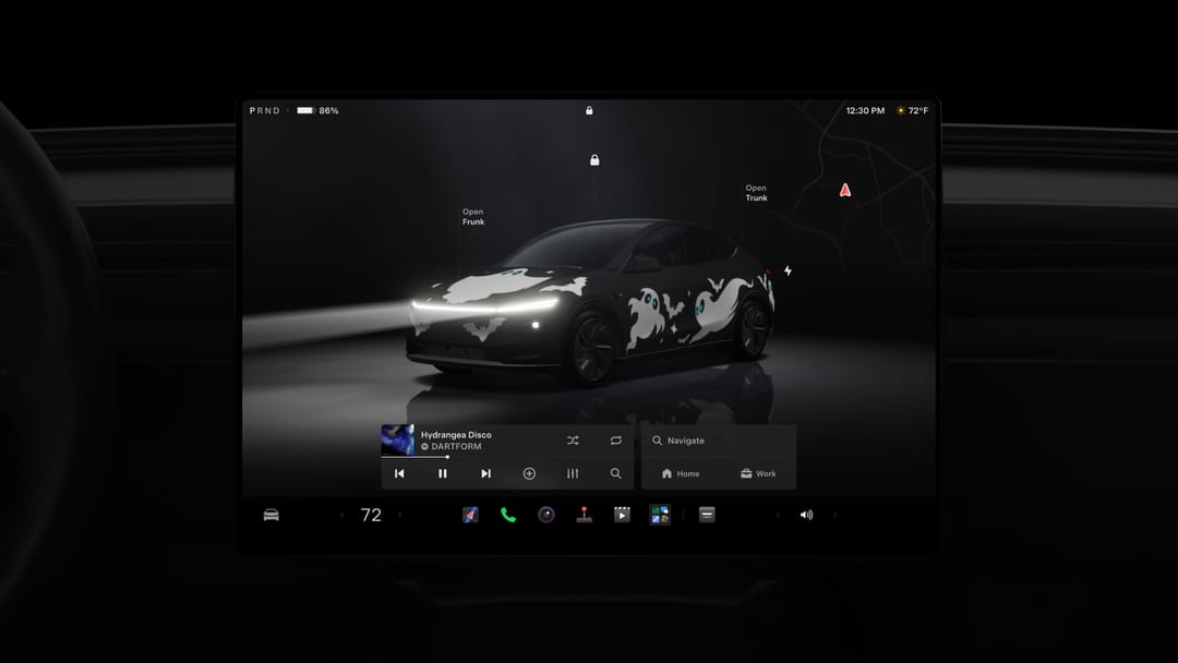 Tesla touchscreen showing a Halloween ghost wrap on the car's avatar, headlights on