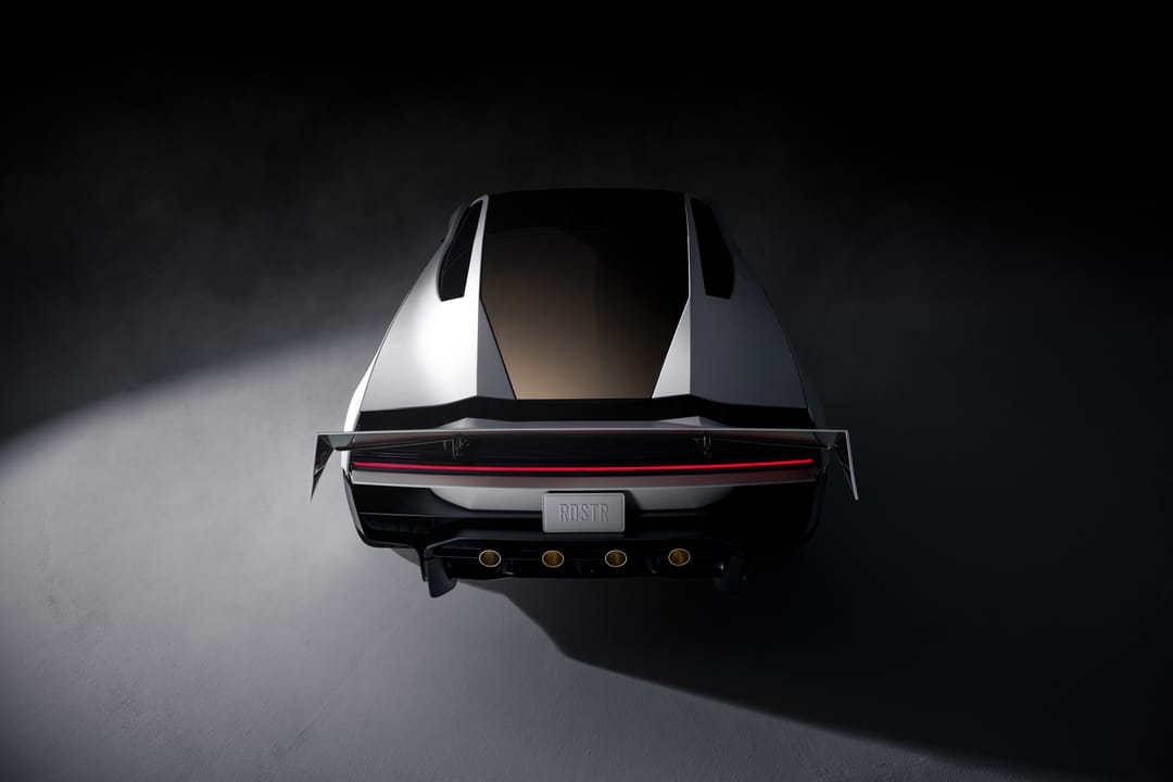 Roadster from behind in a dark studio with the rear wing raised